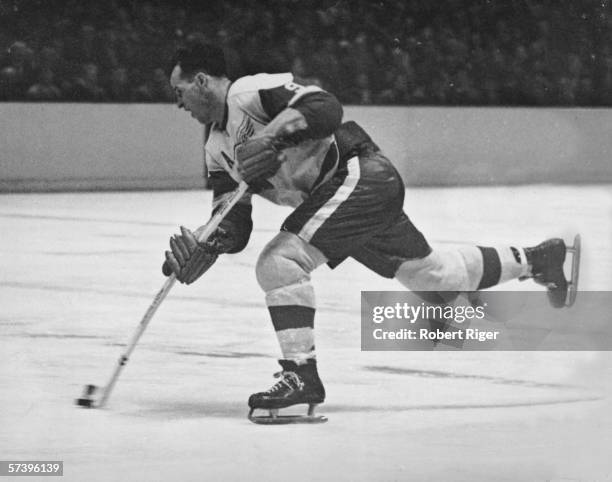 Canadian hockey player Gordie Howe of the Detroit Red Wings fires a shot during a game, late 1950s or early 1960s.