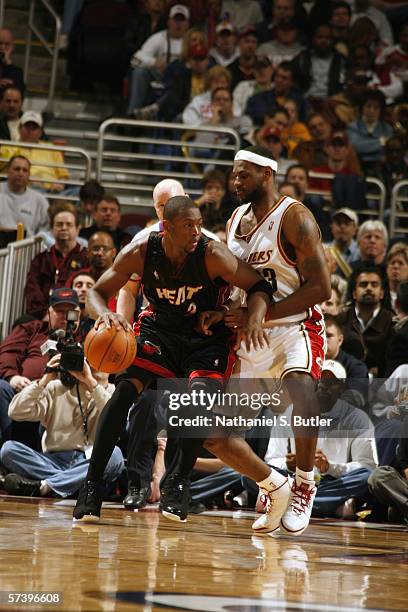 Dwyane Wade of the Miami Heat dribbles against LeBron James of the Cleveland Cavaliers at Quicken Loans Arena on April 1, 2006 in Cleveland, Ohio....