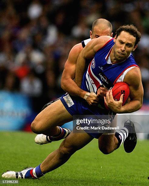 Mitch Hahn for the Bulldogs is tackled by Paul Chapman for the Cats during the round four AFL match between the Western Bulldogs and the Geelong Cats...