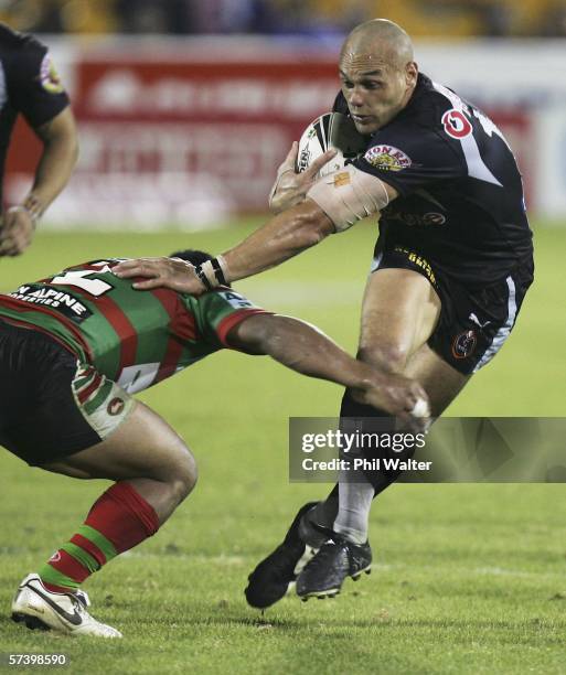 Awen Guttenbeil of the Warriors fends off Nathan Merritt of the Rabbitohs during the Round 7 NRL match between the Warriors and the South Sydney...