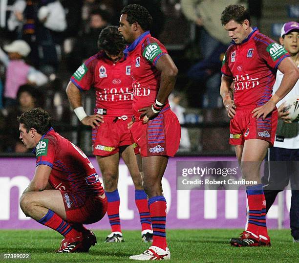 Knights players look dejected after another Storm try during the round seven NRL match between the Melbourne Storm and the Newcastle Knights held at...