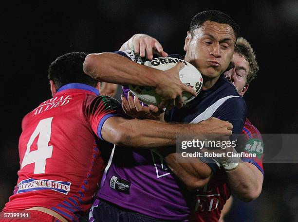 David Kidwell of the Storm is tackled by George Carmont of the Knights during the round seven NRL match between the Melbourne Storm and the Newcastle...