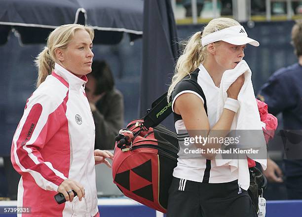 German player Anna-Lena Groenefeld leaves the Center Court with team-captain Barbara Rittner after day one of the Federation Cup World Group...