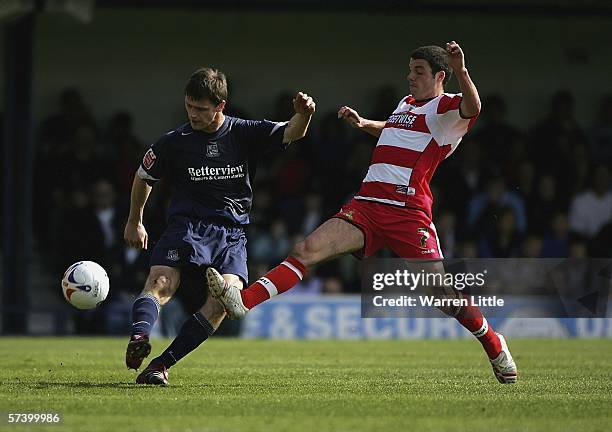 Duncan Jupp of Southend United is tackled by Lewis Guy of Doncaster Rovers during the Coca-Cola League One match between Southend United and...