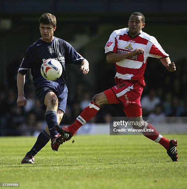 Duncan Jupp of Southend United is tackled by Jermaine McSporran of Doncaster Rovers during the Coca-Cola League One match between Southend United and...