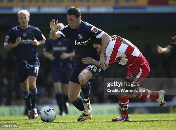 Lee Bradbury of Southend United grabs Sean McDaid of Doncaster Rovers around the neck in a tackle during the Coca-Cola League One match between...