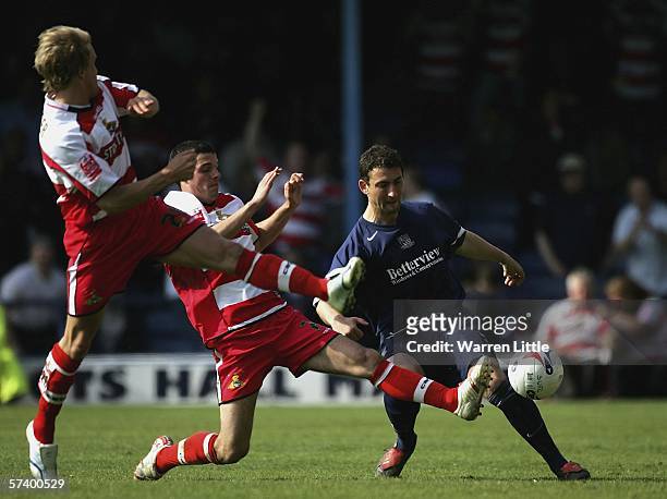 Che Wilson of Southend United clears the ball as tackles fly in high and low from the Doncaster United defence during the Coca-Cola League One match...