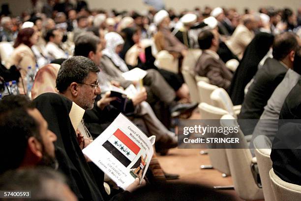 Iraqi Parliament members listen to proceedings during a parliament session, held under tight security in Baghdad's heavily fortified Green Zone, 22...