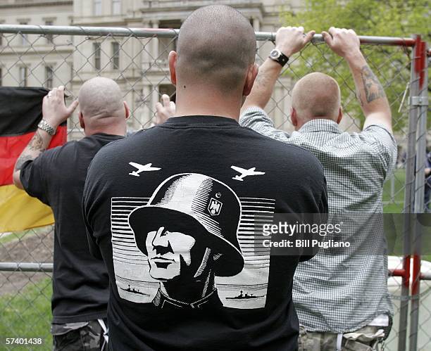 Neo-Nazi supporters listen to a speech during a Neo-Nazi rally at the steps of the Michigan State Capitol Building April 22, 2006 in Lansing,...