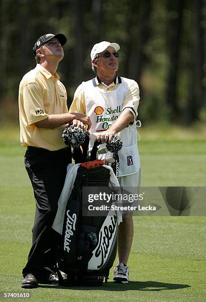 Lucas Glover and his caddie Billy Harmon wait in the fairway on the 6th hole during the third round of the Shell Houston Open at Redstone Golf Club...