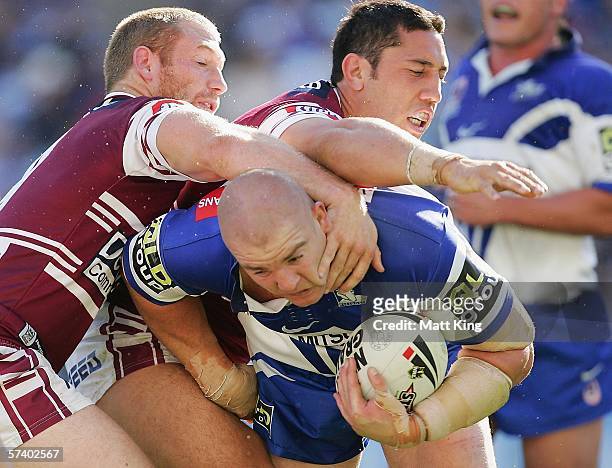 Mark O'Meley of the Bulldogs is tackled by Michael Monaghan and Brent Kite of the Sea Eagles during the round seven NRL match between the Bulldogs...