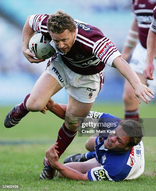 Matt Orford of the Sea Eagles evades the tackle of Corey Hughes of the Bulldogs during the round seven NRL match between the Bulldogs and the...