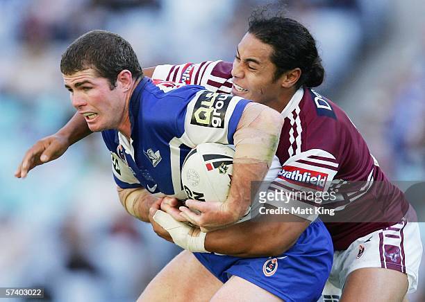 Andrew Ryan of the Bulldogs is wrapped up Steve Matai of the Sea Eagles during the round seven NRL match between the Bulldogs and the Manly-Warringah...