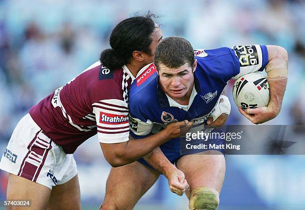 Andrew Ryan of the Bulldogs is wrapped up Steve Matai of the Sea Eagles during the round seven NRL match between the Bulldogs and the Manly-Warringah...