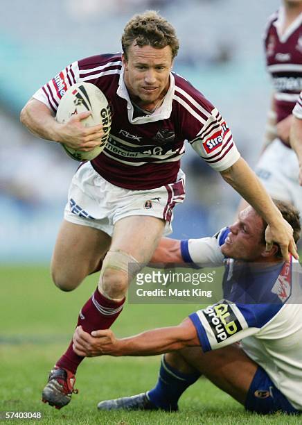 Matt Orford of the Sea Eagles evades the tackle of Corey Hughes of the Bulldogs during the round seven NRL match between the Bulldogs and the...