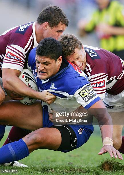 Willie Mason of the Bulldogs is wrapped up by the Sea Eagles defence during the round seven NRL match between the Bulldogs and the Manly-Warringah...