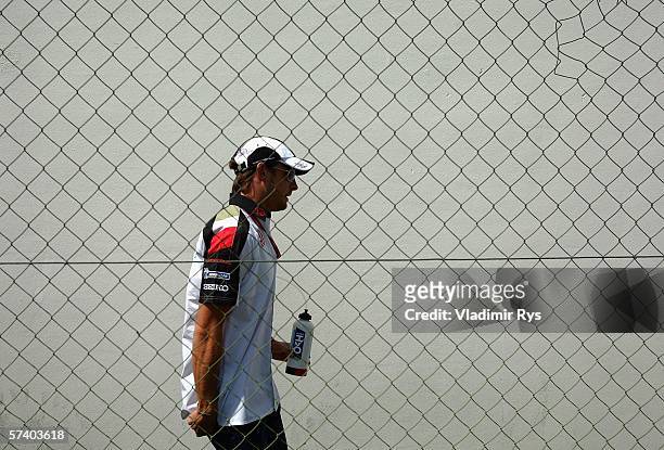 Jenson Button of Great Britain and Honda Racing walks in the paddock after the drivers parade prior to the San Marino Formula One Grand Prix at the...