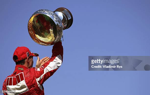 Michael Schumacher of Germany and Ferrari celebrates with the trophy after winning the San Marino Formula One Grand Prix at the San Marino Circuit on...