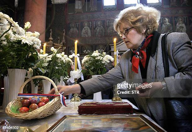 Banja Luka, BOSNIA AND HERCEGOVINA: A Bosnian Orthodox Serb woman, leaves Easter eggs in the church following the Easter Sunday religious service in...