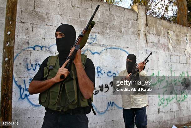 Masked Hamas fighters take their position as they back up Palestinian policemen as they clash with gunmen of the former ruling Fatah faction after...