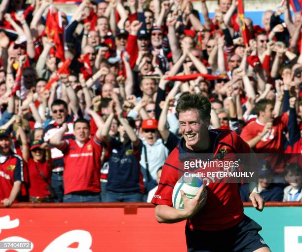 Fans celebrate as Munster player Ronan O'Gara scores a try and clinches the win against Leinster during the second half 23 April 2006 at the semi...