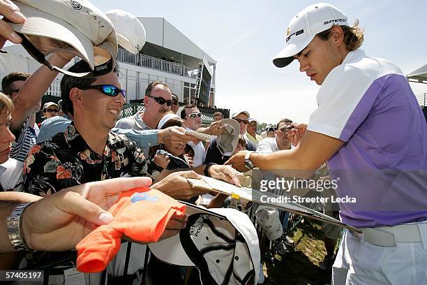 Camilo Villegas of Colombia signs autographs for fans after finishing the final round of the Shell Houston Open on April 23, 2006 at Redstone Golf...