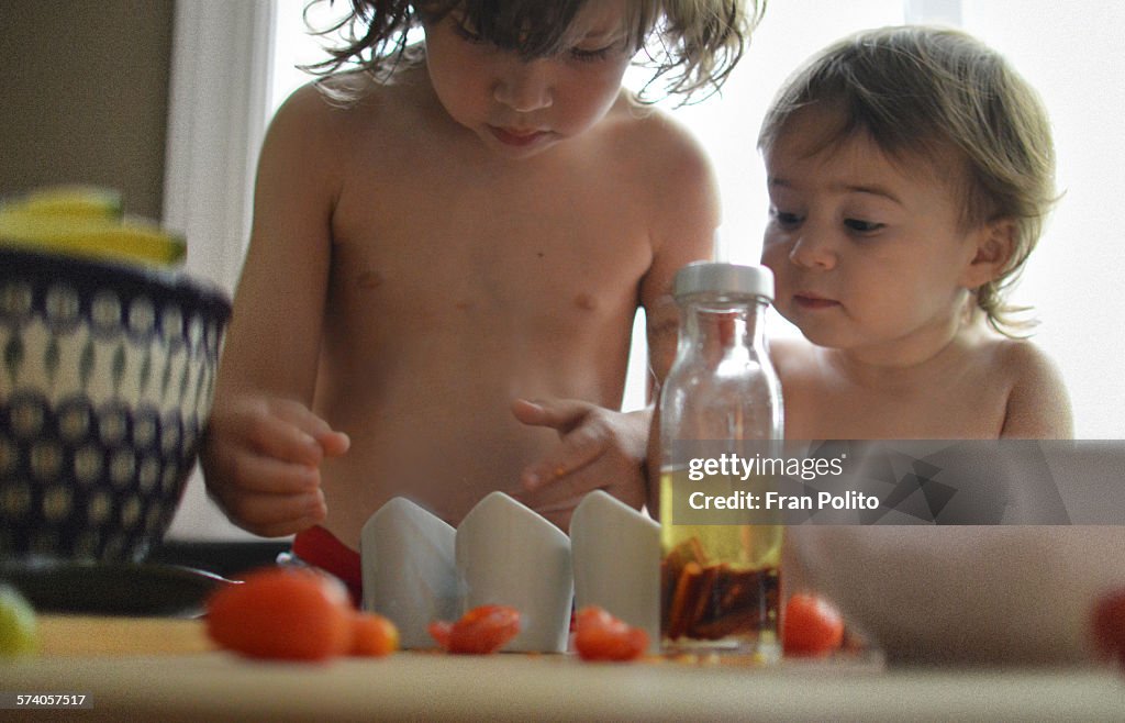 Children cooking in the kitchen with tomatoes