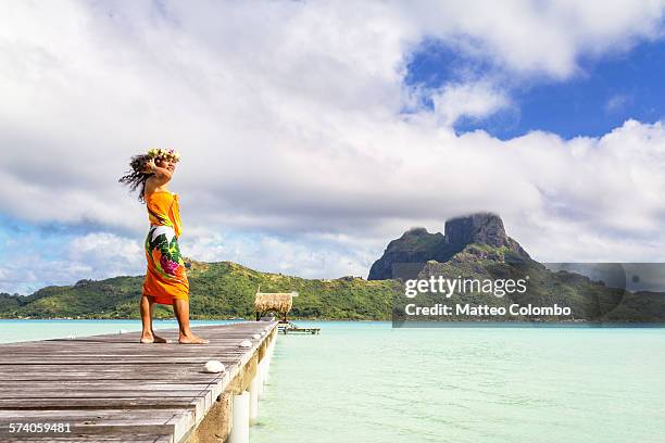 local tahitian woman on jetty, bora bora lagoon - mt otemanu stockfoto's en -beelden