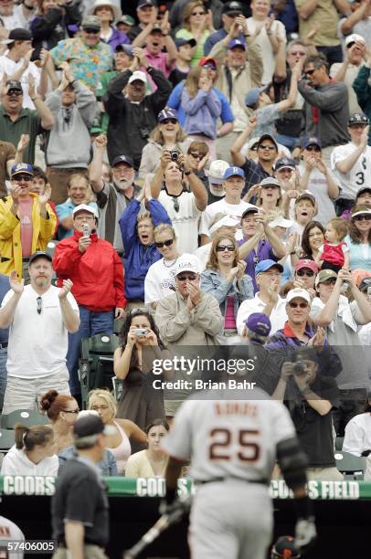 Fans cheer as Barry Bonds of the San Francisco Giants walks back to the dugout after striking out as a pinch hitter in the ninth inning against the...
