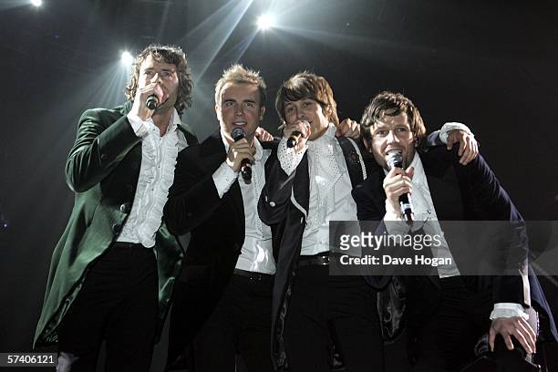 Singers Howard Donald, Gary Barlow, Mark Owen and Jason Orange of Take That perform on stage at the band's opening night of their 'Ultimate Tour...