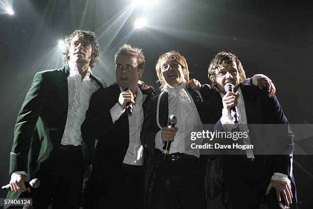 Singers Howard Donald, Gary Barlow, Mark Owen and Jason Orange of Take That perform on stage at the band's opening night of their 'Ultimate Tour...