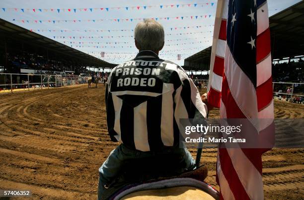 An inmate holds a U.S. Flag during the Angola Prison Rodeo at the Louisiana State Penitentiary April 23, 2006 in Angola, Louisiana. The Angola Prison...