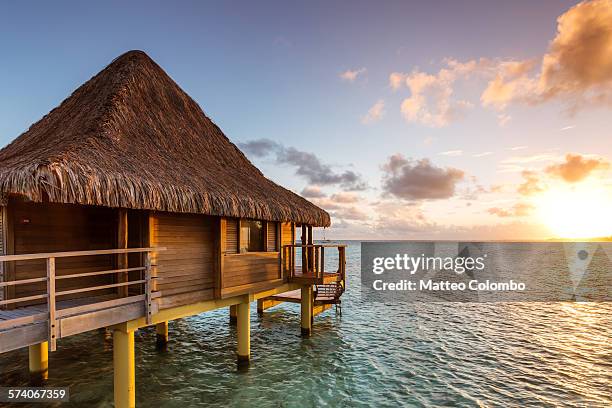 over water bungalow at sunset, rangiroa, polynesia - rangiroa atoll stock pictures, royalty-free photos & images