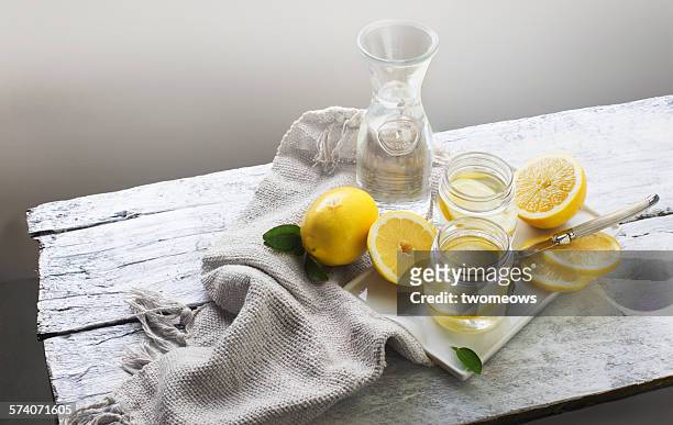 lemon water on white wooden table. still life. - lemon stock pictures, royalty-free photos & images