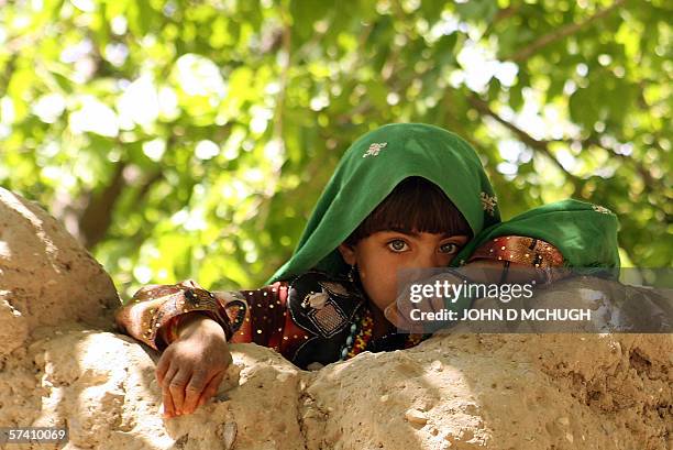 Kandahar, AFGHANISTAN: An Afghan child watches as members of the 1st Princess Patricia's Canadian Light Infantry leave after searching a village in...