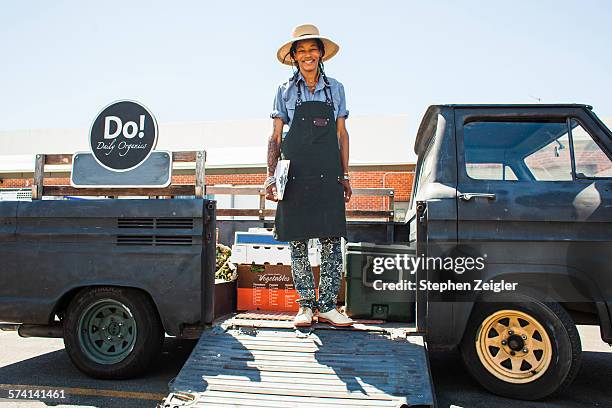 Woman standing in the back of her vintage truck