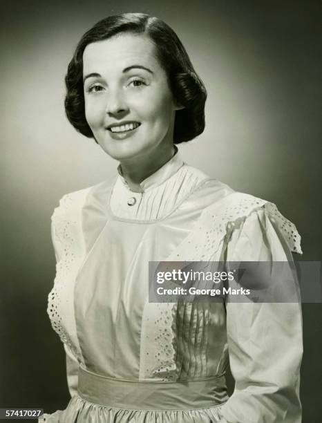 woman in white apron posing in studio, (b&w), (portrait) - 1950 females only housewife stock pictures, royalty-free photos & images