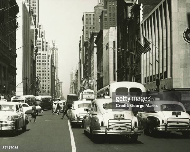 busy street in new york city , (b&w) - 1950's cars ストックフォトと画像