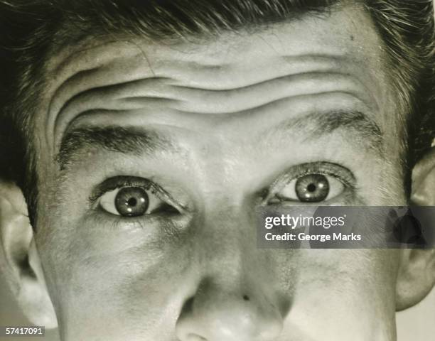 man furrowing brow, (b&w), (close-up), (mid section) - frowning stock pictures, royalty-free photos & images