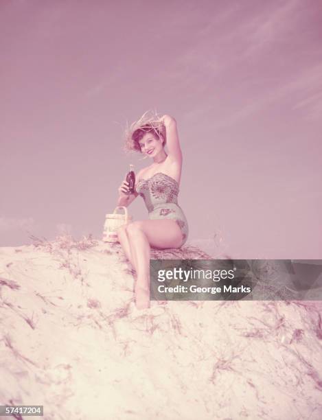 young woman relaxing on beach with drink - beach glamour stock pictures, royalty-free photos & images