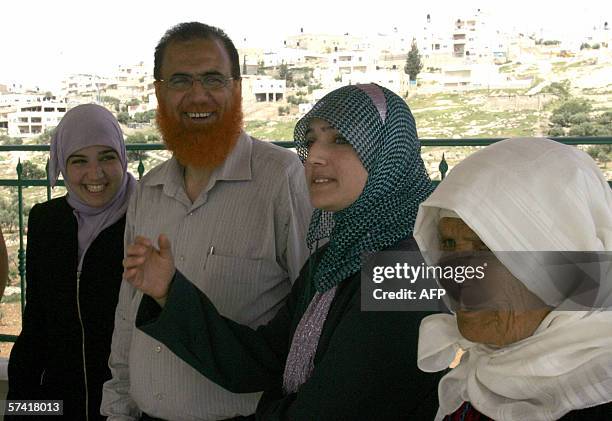 Hamas MP Mohammed Abu Teir stands on the balcony with members of his family, from left to right: his daughters Mariam, Arwa and his mother Heyjar at...