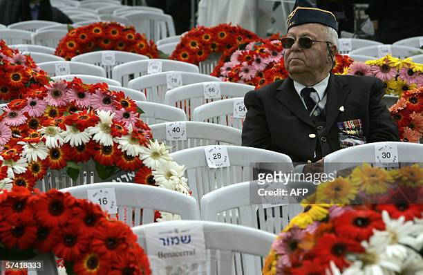 War veteran sit next to wreaths before the start of annual Holocaust Martyrs and Heroes Remembrance Day ceremonies at the Yad Vashem Holocaust...
