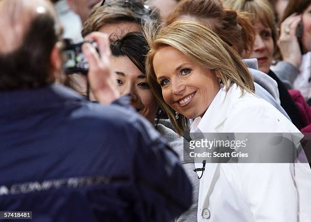 "Today" show anchor Katie Couric poses for a photo with a fan before Sir Elton John's performance live on the Toyota Concert Series in Rockefeller...