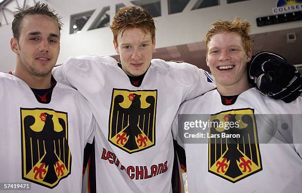 Felix Schuetz, Philip Gogulla and Christoph Gawlik of Germany pose after winning the IIHF World Championship Division 1 Group A match between Germany...