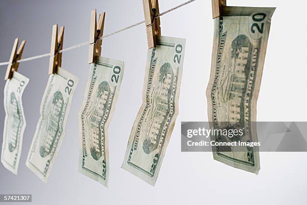 banknotes on a clothesline - money laundering stock pictures, royalty-free photos & images