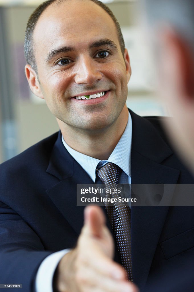 Businessman with food in his teeth