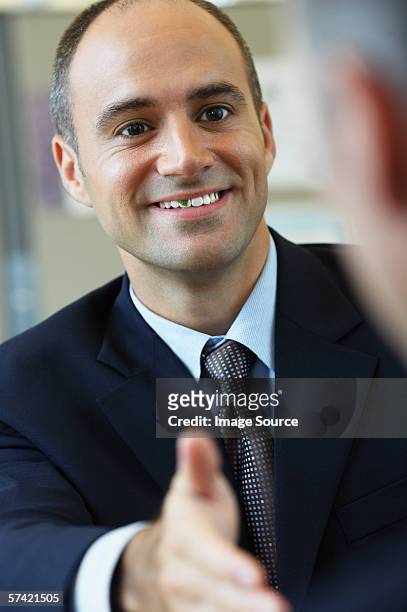 businessman with food in his teeth - awkward handshake stock pictures, royalty-free photos & images