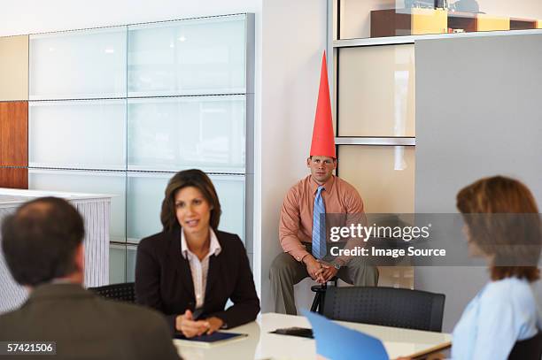 business meeting with dunce sat in corner - dumstrut bildbanksfoton och bilder