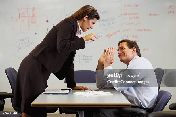 businesswoman shouting at colleague - role reversal stock pictures, royalty-free photos & images