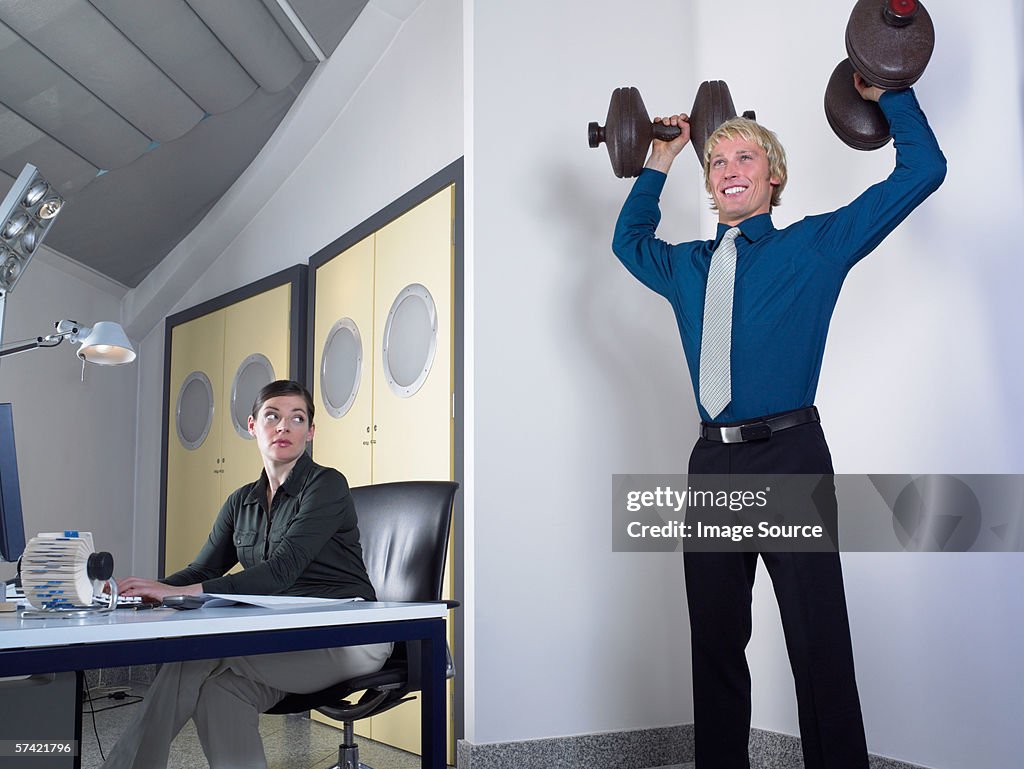 Office worker lifting weights